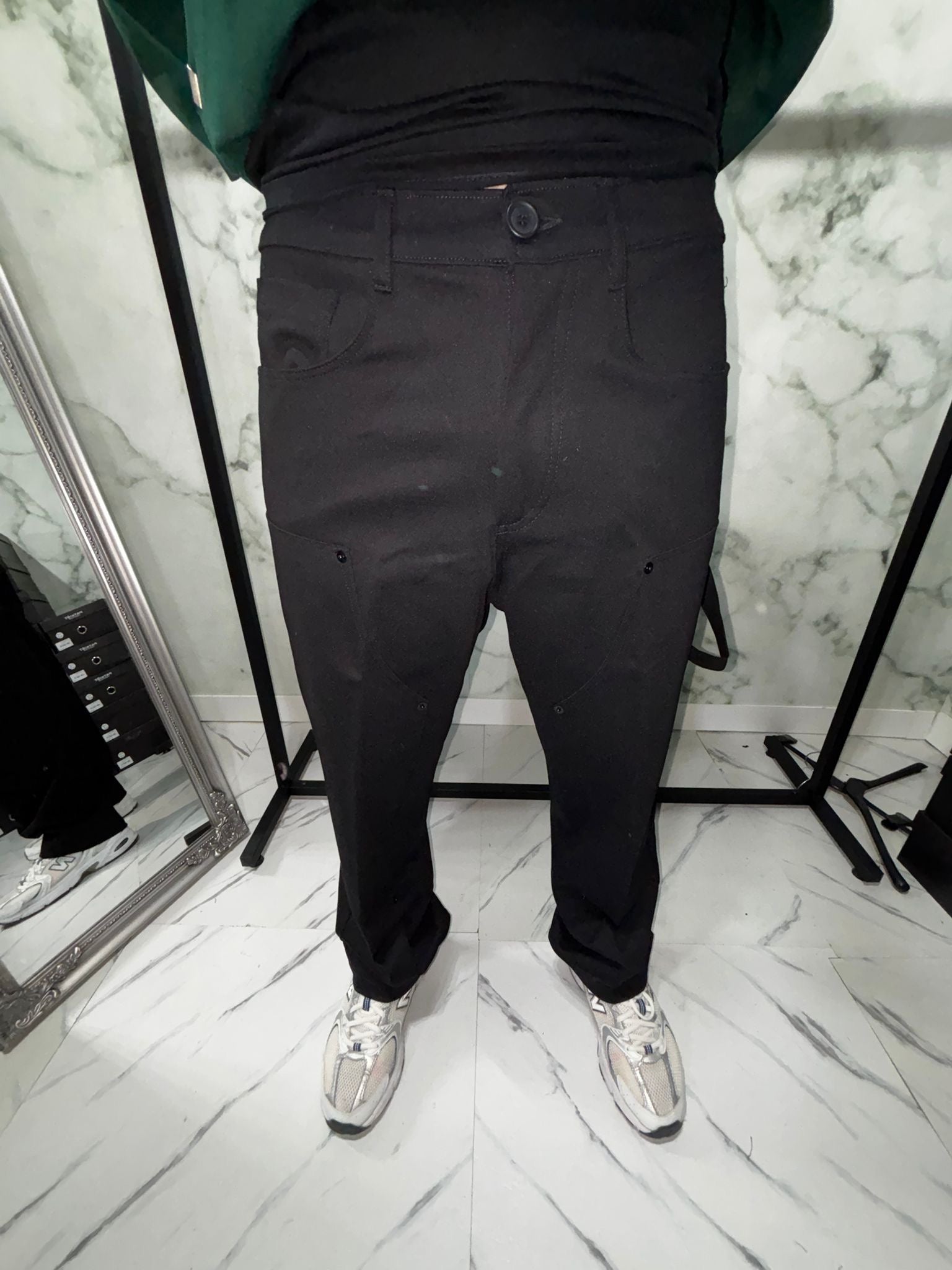 Person wearing Cargo 2.0 Tech Baggy pants in black with sneakers, displaying the baggy fit and modern style.